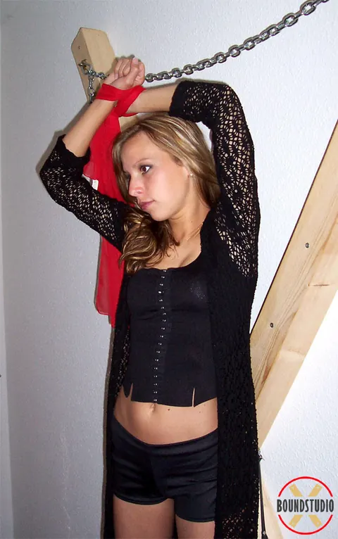 Blonde Bound to a Cross in Shorts and Boots – photo 2 of 16
