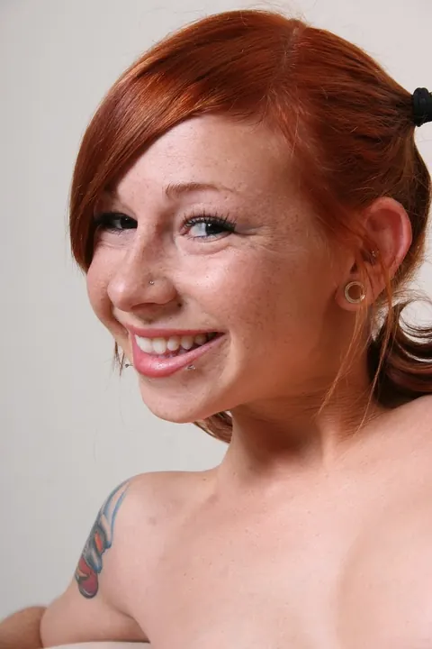 Scarlett Pain: Redhead with Pigtails Poses Naked Showing Her Tattoos and Pierced Tits – photo 19 of 21