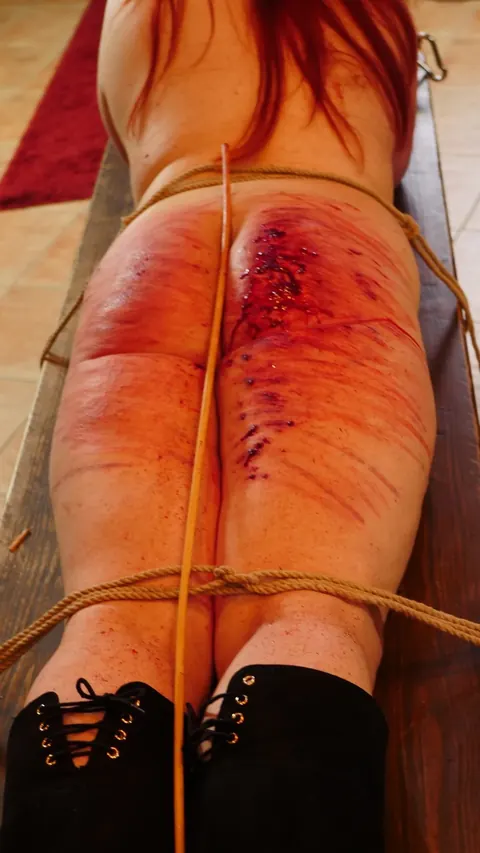 Redhead MILF Bound to Table Takes Hard Caning on Her Ass – photo 16 of 21