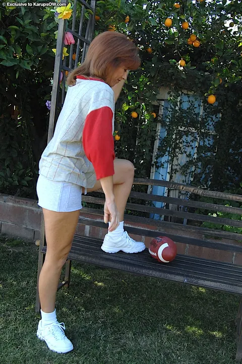 Mikela Kennedy: Mature Blonde in Shorts Undresses Outdoors – photo 1 of 16
