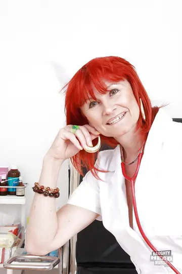 Busty Mature Redhead Nurse in Stockings Toys Her Pussy
