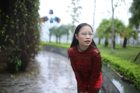 Asian Brunette Poses in Glasses Outdoors in a Public Place – photo 3 of 21