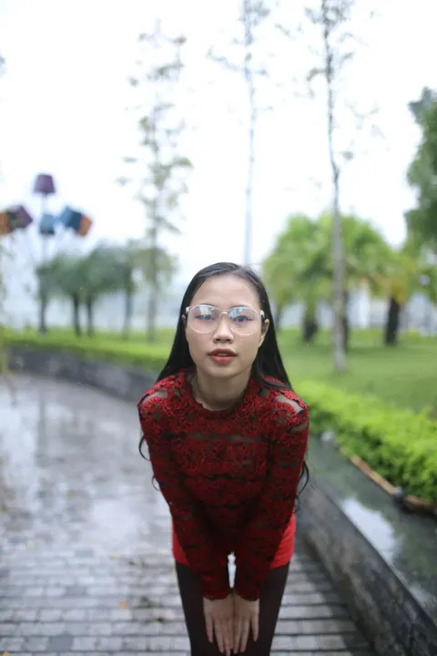 Asian Brunette Poses in Glasses Outdoors in a Public Place – photo 6 of 21