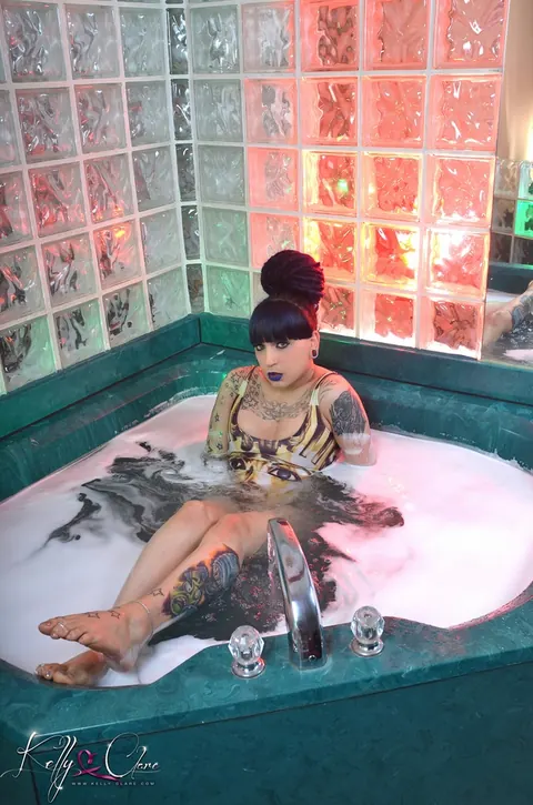 Tattooed Trans Woman Oils Her Body in a Bikini – photo 3 of 16