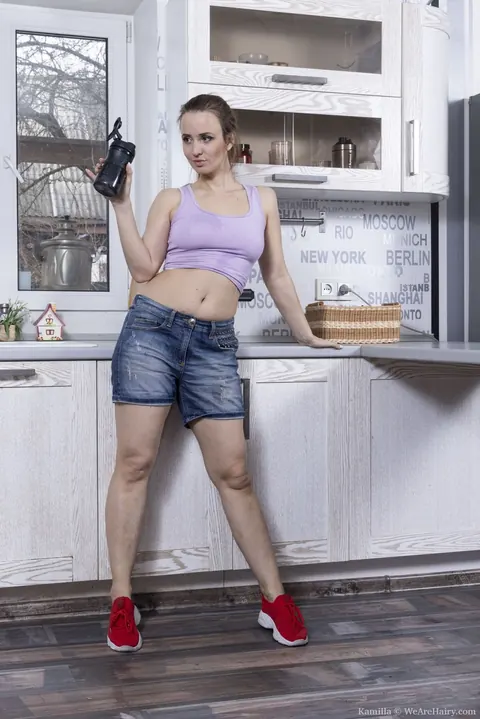 Woman Strips in the Kitchen and Masturbates Hairy Pussy with a Dildo – photo 1 of 21