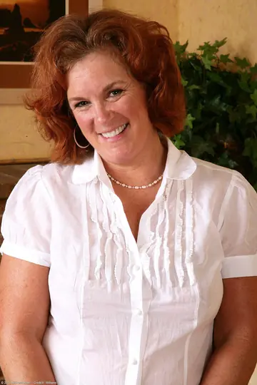 Curvy Redhead MILF Strips Out of Her Pantyhose and Fingers Her Hairy Pussy