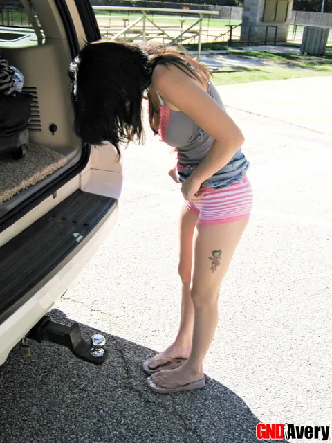 Tattooed Brunette Flashes Behind a Minivan in Public – photo 9 of 12