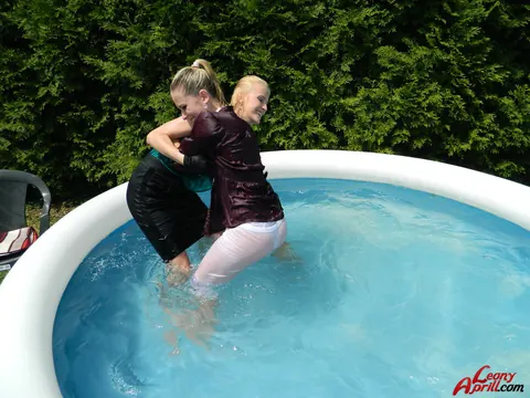 Two Women Kiss in an Outdoor Pool – photo 7 of 15