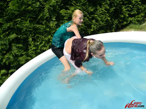 Two Women Kiss in an Outdoor Pool – photo 12 of 15