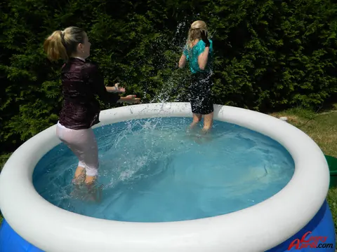 Two Women Kiss in an Outdoor Pool – photo 5 of 15