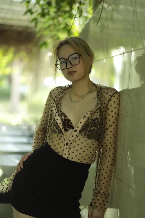 Asian Blonde in Glasses and Skirt Strips Outdoors – photo 7 of 21