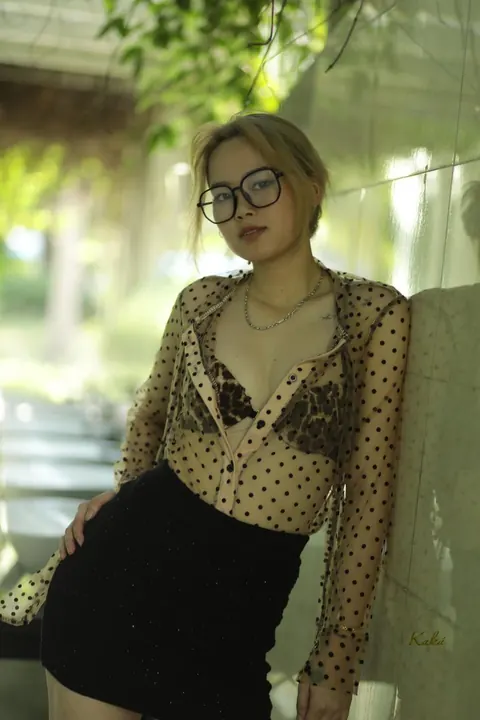 Asian Blonde in Glasses and Skirt Strips Outdoors – photo 6 of 21