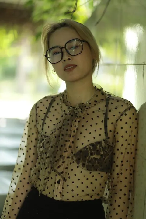 Asian Blonde in Glasses and Skirt Strips Outdoors – photo 16 of 21