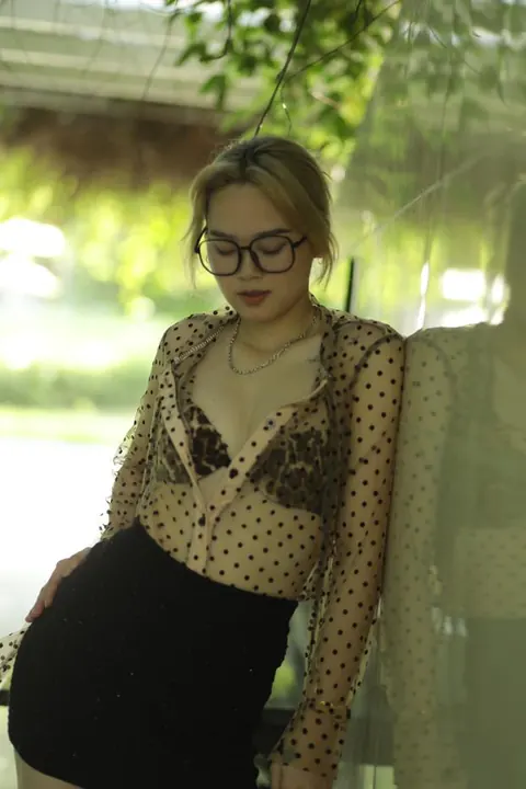 Asian Blonde in Glasses and Skirt Strips Outdoors – photo 9 of 21
