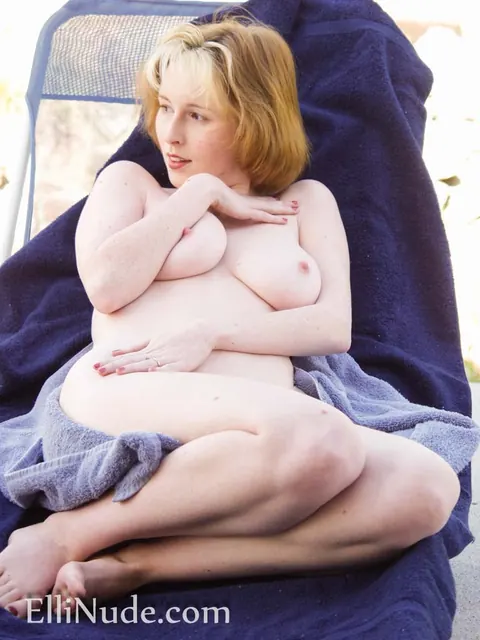 Elli Nude: Busty Redhead MILF Fingers Her Pussy on Lounge Chair – photo 2 of 12