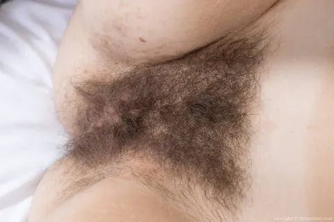 Lira Light: Redhead Undresses and Rubs Her Hairy Pussy – photo 12 of 21