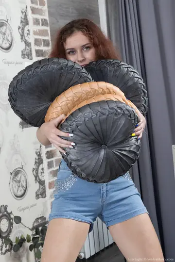 Redhead Undresses and Rubs Her Hairy Pussy