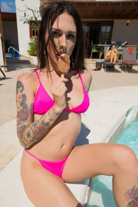 Tattooed Brunette Strips Off Her Bikini Top by the Pool – photo 2 of 12