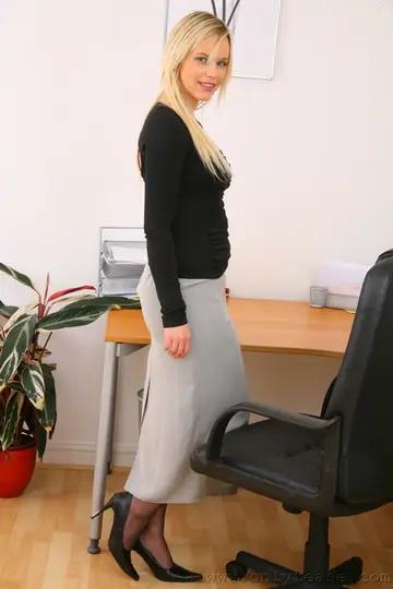 Busty British Blonde Poses in a Skirt and Stockings at the Office