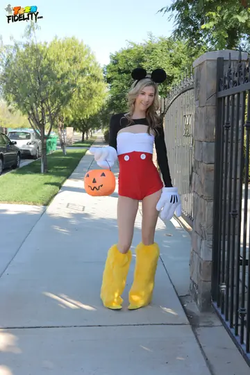 Skinny Blonde Poses in a Halloween Costume Outdoors