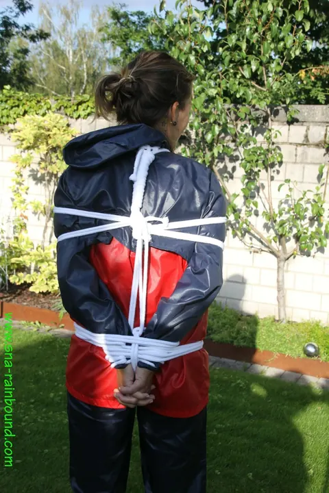 Woman Stands Bound in Restraints Outdoors – photo 2 of 16