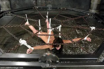 Tattooed Brunette in Bondage Spreads Her Pussy