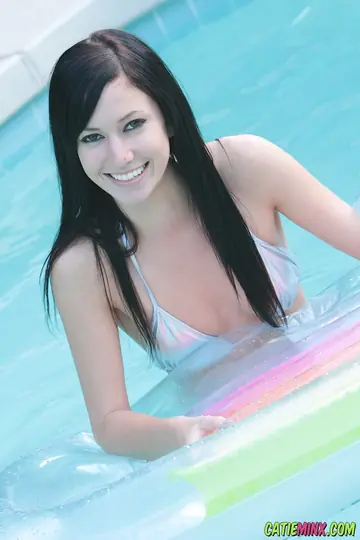 Busty Brunette Strips Out of Her Bikini on a Pool Air Mattress