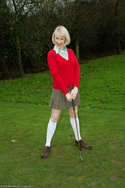 Hazel May: Mature Blonde in a Golf Uniform Spreads Her Hairy Pussy Outdoors – photo 1 of 20