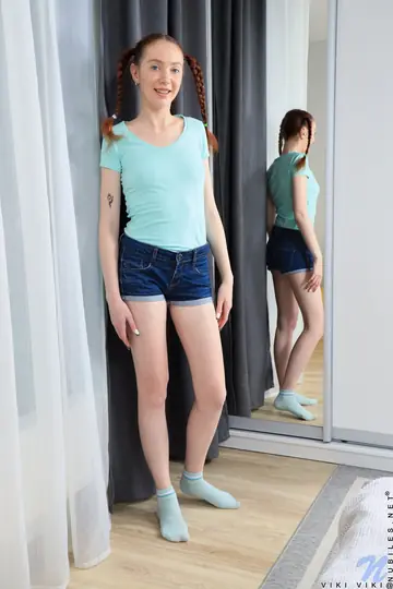 Slim Woman in Denim Shorts and Socks Masturbates with a Dildo