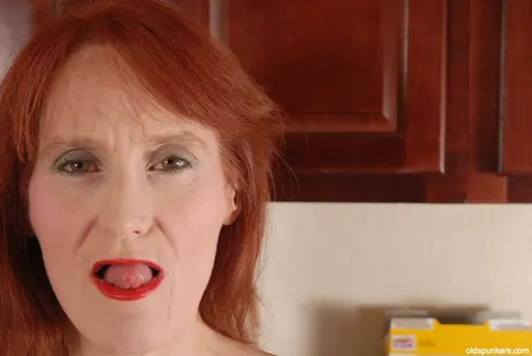 Redhead Granny Fingers Her Shaved Pussy – photo 1 of 16