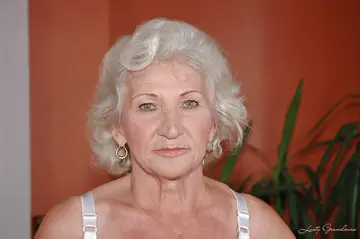 Busty Granny Masturbates with a Dildo in Lingerie and Stockings