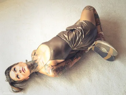 Tattooed Brunette Bound in a Hogtie Wearing a Skirt – photo 2 of 16
