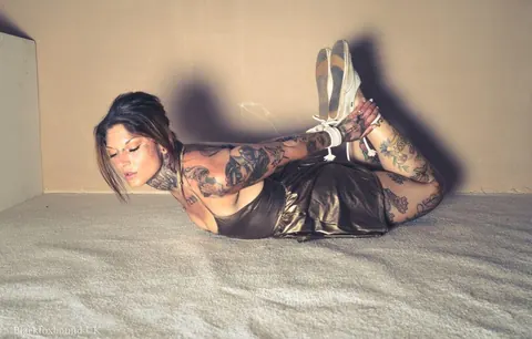 Tattooed Brunette Bound in a Hogtie Wearing a Skirt – photo 16 of 16
