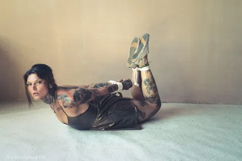 Tattooed Brunette Bound in a Hogtie Wearing a Skirt – photo 10 of 16