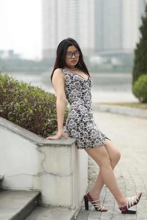 Asian Woman Poses in a Dress and Heels Outdoors – photo 19 of 21