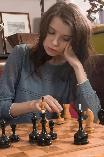 Slim Brunette Strips After Losing Strip Chess and Spreads Her Hairy Pussy