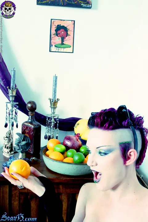 Scar 13: Tattooed Short-Haired Brunette Bites Citrus Fruit Nude – photo 4 of 15