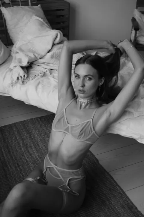 Slim Woman Models Lingerie in Her Bedroom – photo 3 of 11