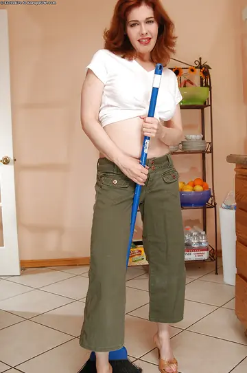 Redhead MILF in Heels Strips and Uses a Dildo