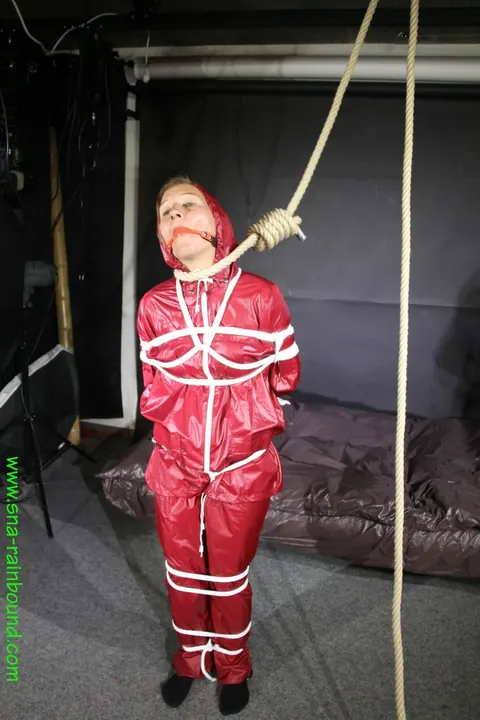 Woman in Raincoat Bound and Gagged with Ball Gag – photo 14 of 16
