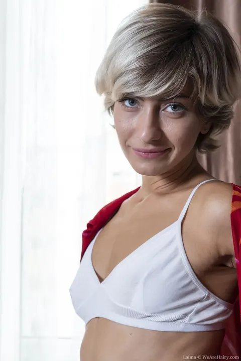 Laima: Slim Short-Haired Blonde Bares All and Fingers Her Hairy Pussy – photo 3 of 20