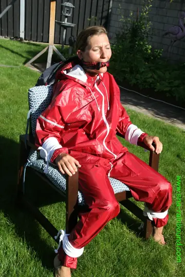Amateur in Latex Bound to a Chair Outdoors