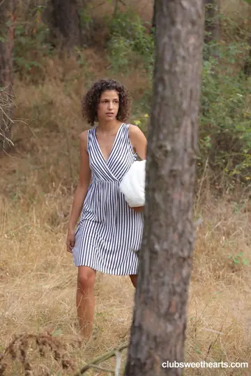 Curly European Brunette Lifts Her Dress to Finger Her Pussy in the Forest
