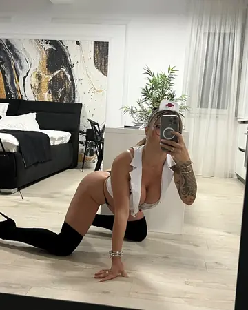 Blonde Nurse with Big Tits Poses in Stockings and Heels for Mirror Selfies