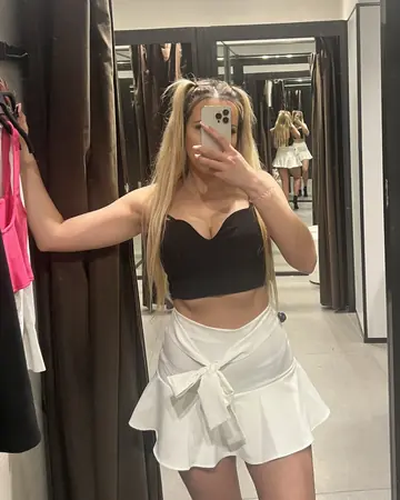 Woman Models Revealing Outfits and Flaunts Her Ass