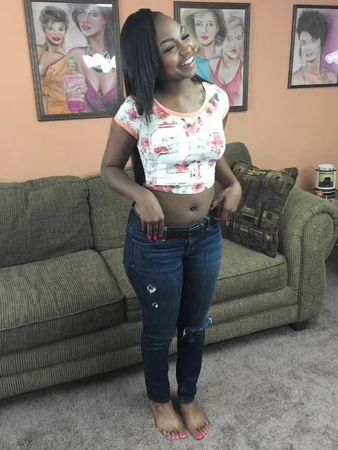 Nikki Ford: Petite Ebony MILF in Jeans Fingers Her Pussy on the Sofa – photo 2 of 20