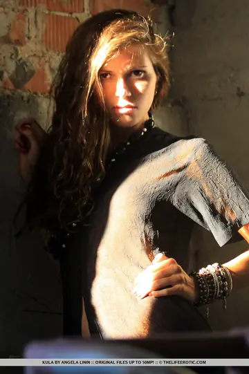 Hairy Woman Undresses by a Brick Wall and Spreads Her Pussy