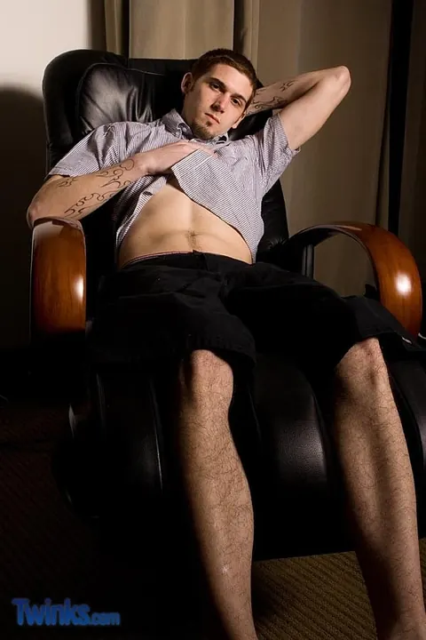 Brunette Guy Strips in a Chair and Jerks His Cock – photo 1 of 21