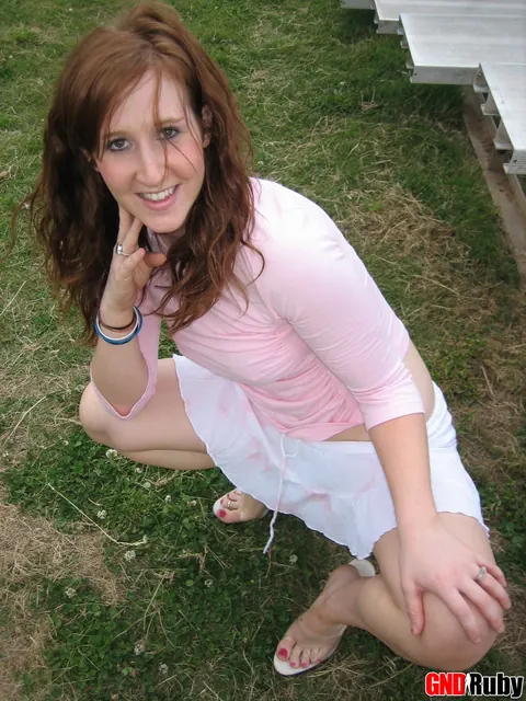 Redhead Flashes Panties in a Skirt and High Heels on Bleachers – photo 9 of 12