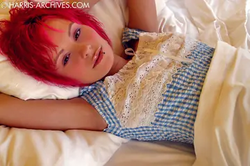 Redhead Strips and Bares Her Pierced Tits on the Bed